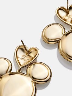 Show off your Disney love with the Mickey Mouse Disney Gold Heart Earrings. These earrings feature Mickey with love literally sitting on his head. Fully colored in gold, this statement piece pairs well with any ‘fit. This is an officially licensed Disney product. Gold Mickey Mouse Jewelry For Gift, Disney Gold Earrings As Gift, Disney Gold Earrings For Gift, Gold Disney Earrings For Gift, Gold Disney Mickey Mouse Jewelry, Disney Gold Mickey Mouse Jewelry, Disney Mickey Mouse Gold Jewelry, Gold Heart Earrings, Disney Gold