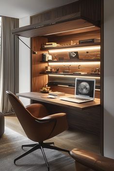 a desk with a laptop on it in front of a window and a chair next to it