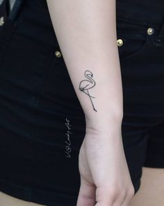 a woman's arm with a small tattoo on the left side of her wrist