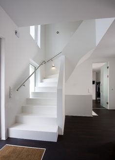 a white staircase leading up to the second floor