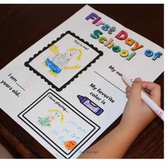 a child's hand holding a pencil over a piece of paper with the words first day school written on it