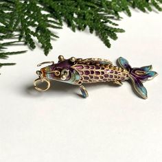 This beautiful articulated fish pendant is Chinese and quite old, possibly antique. It is made of sterling silver and artfully applied enamel.  The purple fish is unmarked, but I've tested it with nitric acid to confirm it is completely silver.  It is in good vintage condition, with 3 or 4 scales with damaged enamel (see photos), which are hard to notice.  Length: 54mm (2.1 inches) Weight: 6.75 grams Message if you have any questions  : )   Vintage jewelry: good for humanity and the earth. By bu Articulated Fish, Violet, Favorite Jewelry, Vintage Jewelry, Jewelry Necklace Pendant, Jewelry Necklaces, Pendant Necklace, Accessory Gift, Electronic Accessories