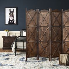 a room divider made out of wood with a dog on the wall behind it