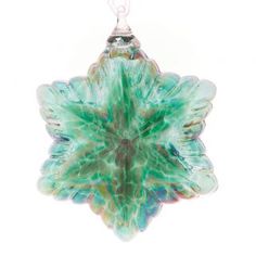 a green glass ornament hanging from a chain