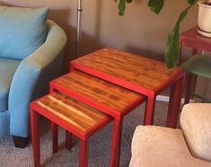 three wooden tables sitting next to each other in front of a blue couch and chair