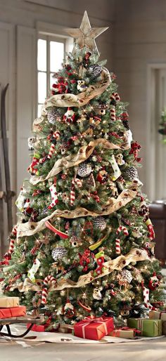 a christmas tree decorated with ribbons and ornaments