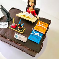 a cake with a doll sitting on top of it next to scissors and other items