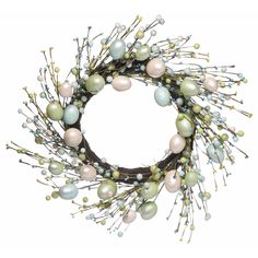 a wreath with white and green ornaments on it