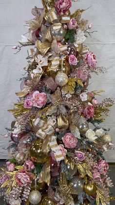 a christmas tree decorated with pink and gold ornaments