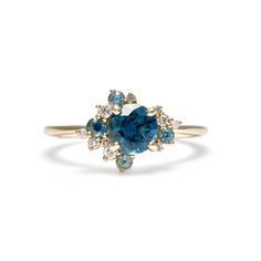 a blue diamond ring with two diamonds on the side and one stone in the middle