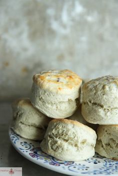 some biscuits are stacked on top of each other in a blue and white plate with designs