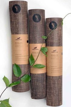 three yoga mats are stacked on top of each other with leaves growing out of them