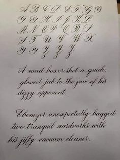 an old fashioned calligraphy is displayed on a piece of paper with cursive writing