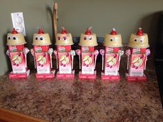 five baby bottles with faces on them sitting on a counter top in front of a microwave