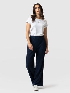 Our Victory Rib Wide Leg Pant in navy is a wide-leg pant with rib detailing. It features a comfortable elasticated waist in a brushed melange navy rib. We made it with a smooth, textured viscose with stretch. Style it with our matching Victory Rib Top in navy or wear it alone with a chunky black knit and a pair of sneakers for daywear or ankle boots for the evening. | Saint + Sofia Women's Victory Rib Wide Leg Pants, Navy, Viscose, Size US 6 Length Regular Trousers Women Wide Leg, Womens Wide Leg Pants, Rib Top, We Made It, Trouser Style, Wide Leg Pant, Chunky Boots, Knit Pants, Black Knit