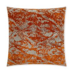 an orange and grey pillow on a white background with the image of mountains in the distance