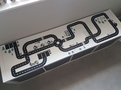 a paper model of a road with cars on it