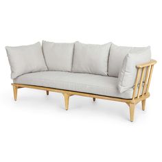 a white couch sitting on top of a wooden frame next to two gray pillows and a light colored pillow