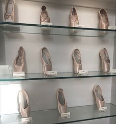 there are many pairs of ballet shoes on display