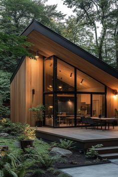 a modern house in the woods surrounded by trees