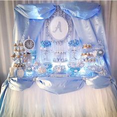 a blue and white dessert table set up for a baby shower