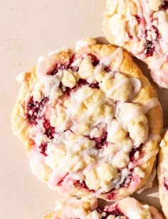 several cookies with icing and crumbs on a table