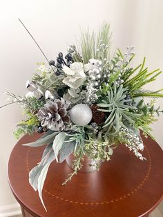 a vase filled with flowers sitting on top of a wooden table