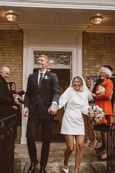 a bride and groom walking down the aisle