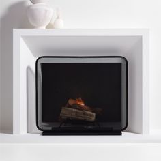 a white fireplace with a black fire place