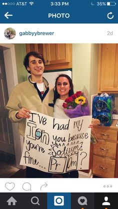 a man and woman holding up a sign