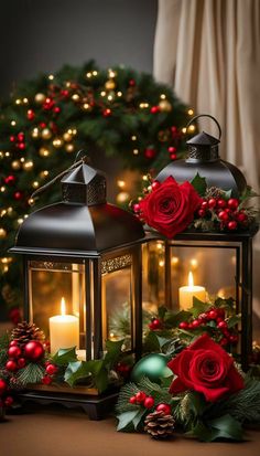 two christmas lanterns with red roses and greenery