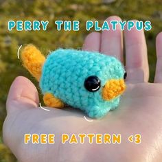 a small crocheted blue bird sitting on top of a persons hand with the words perny the platypus below it