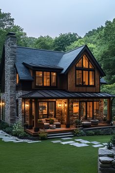 a large house in the middle of a lush green field