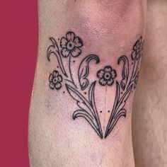 a black and white flower tattoo on the leg