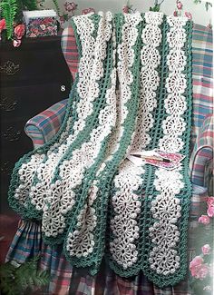 a crocheted blanket sitting on top of a couch next to a plaid chair