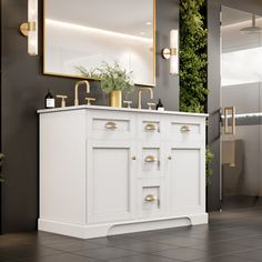 a white bathroom vanity with two sinks and mirrors on the wall next to a mirror