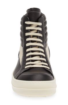 Crafted from full-grain leather and suede, this high-top sneaker is quintessentially Rick Owens with its blunted toe, dramatic lacing and shark-tooth sole. Drawing inspiration from vintage silhouettes and color schemes, this boldly topstitched shoe blends modern comfort with a timeless aesthetic. Lace-up style Leather upper and lining/rubber sole Made in Italy Designer Shoes Leather High-top Sneakers With Vulcanized Sole For Streetwear, High-top Sneakers With Leather Sole, Leather High-top Boots With Vulcanized Sole, Leather High-top Sneakers With Rubber Sole For Streetwear, High-top Leather Sneakers With Gum Sole, Calf Leather High-top Sneakers With Rubber Sole, Modern High-top Sneakers With Leather Sole, Designer High-top Sneakers With Vulcanized Sole, Mid-top Leather Boots With Vulcanized Sole