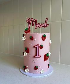 a pink birthday cake with strawberrys and flowers on the top that says march 1