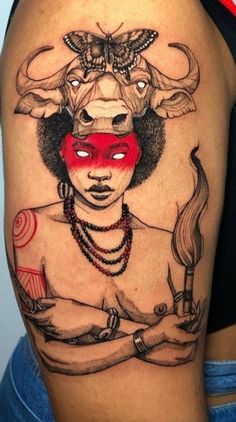 a woman with a bull's head on her face is depicted in this tattoo