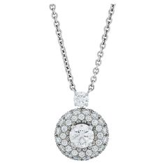 Graff round diamond halo pendant necklace in 18k white gold. This Graff necklace features a 0.70 carat round brilliant cut diamond with G color and VS clarity, surrounded by a halo of pave set diamonds. The total diamond weight of the necklace is approximately 2.20 carats. The pendant measures 12.65mm 16.5" chain. Numbered and signed Graff. Graff Necklace, Round Diamond Halo, Halo Pendant, Diamond Halo, Drop Necklace, Round Brilliant Cut Diamond, Brilliant Cut Diamond, Halo Diamond, Round Brilliant