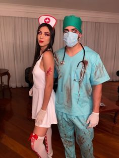 a man and woman in scrubs standing next to each other wearing surgical garb