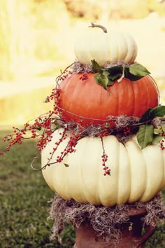 three pumpkins stacked on top of each other in the grass with words above them