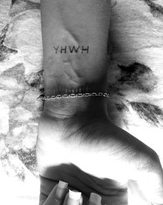 a woman's foot with the word hwhy tattooed on her left ankle