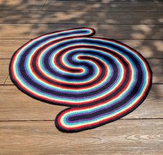 a multicolored rug is laying on a wooden floor