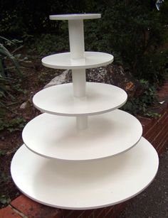 three tiered white cake stand in the garden