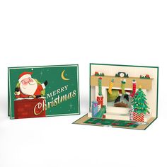 an open christmas card with a fireplace and santa clause