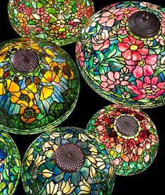 several colorful glass bowls with flowers on them