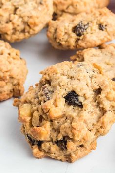 several oatmeal raisin cookies on a white surface