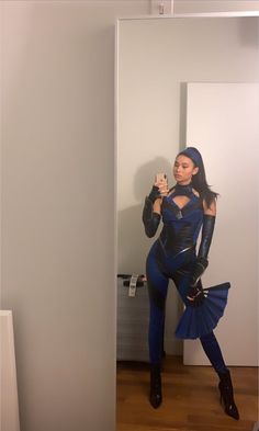 a woman is taking a selfie in the mirror with her cell phone while wearing a costume