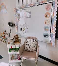 a chair and table in front of a white board with many pictures on it,